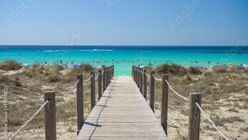 Wooden path over the sandy beach to the turquoise sea of Son Bou in Menorca, Spain © MEDIAIMAG
