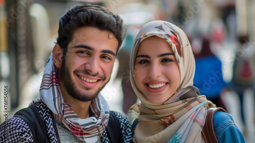 Middle Eastern man and woman smiling for the camera.