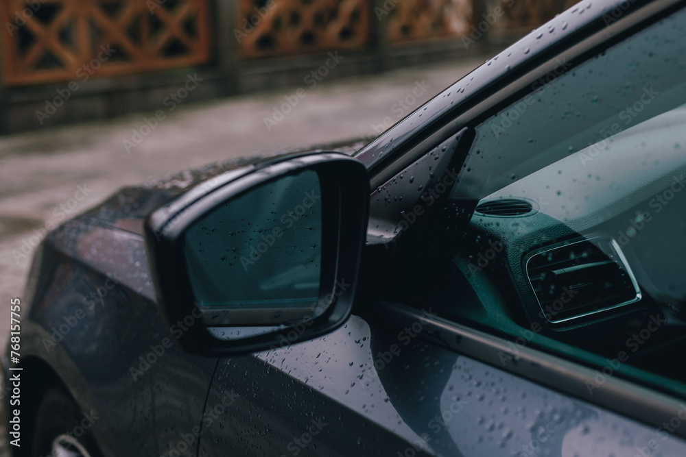 Side rearview mirror of the car in a rain drops Side rearview mirror of the car in a rain drops