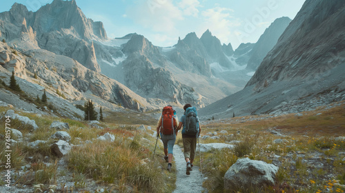  Against the backdrop of towering mountains, a hiker couple traverses a rugged trail hand in hand. Their faces are filled with determination and excitement.