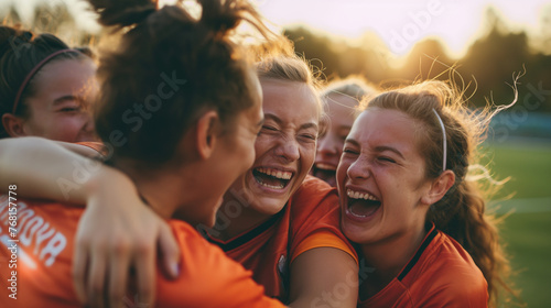 Their arms raised high in triumph as they revel in their hard-earned victory on the soccer pitch, a spirited group of young female players erupts into jubilant celebration. 