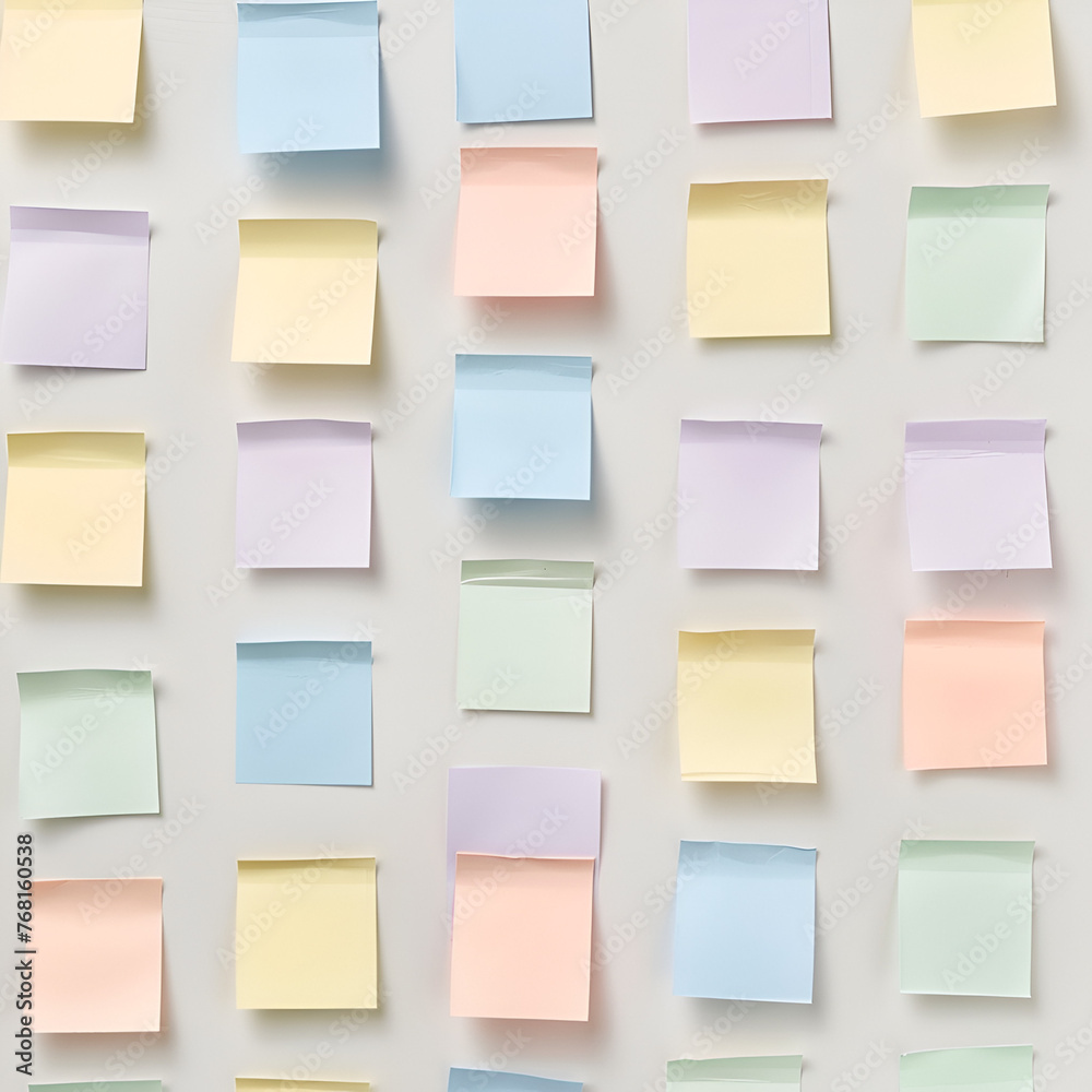 Fototapeta premium post it notes in different pastel colours on wall in perfect lines
