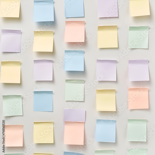 post it notes in different pastel colours on wall in perfect lines