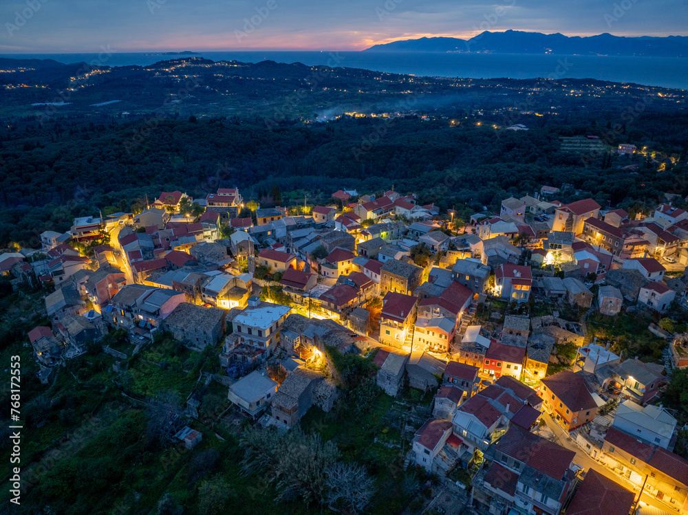 Aerial drone view of Nymfes mountain village by night, Corfu, Greece
