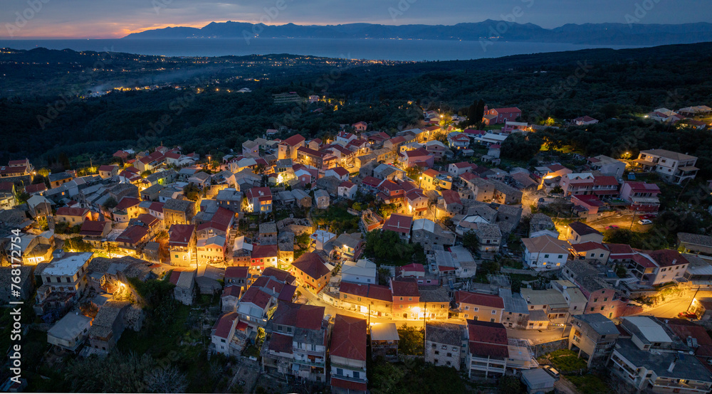 Aerial drone view of Nymfes mountain village by night, Corfu, Greece
