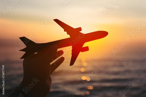 Toy airplane in hand, symbolic of travel aspirations taking flight