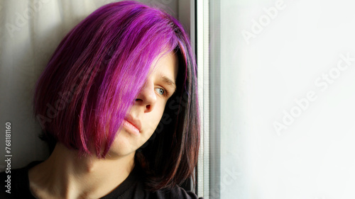 A Trendy boy with purple hair. mental health, transitional age. A color image of a teenage boy with dyed hair, youth, emotions, lifestyle