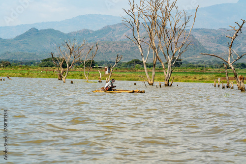 Ethiopia, fisherman in his boat  and view from the Lake chamo on the surounding landscape. photo