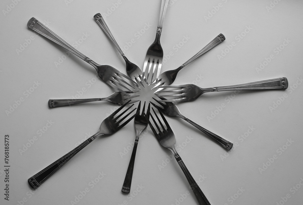 Table Forks And Cake Forks From One Cutlery Set Laid Out In Form Of Star Concept Photo For Design Or Backgrounds
Table Forks And Cake Forks From One Cutlery Set Laid Out In Form Of Star Concept Photo For Design Or Backgrounds
