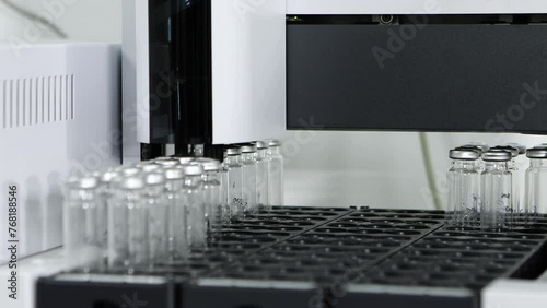 Close up of science experiment Vials filling inside an autosampler automatically picked my equipment of an HPLC machine in a Scientific experimental laboratory for research and ipqa test study photo