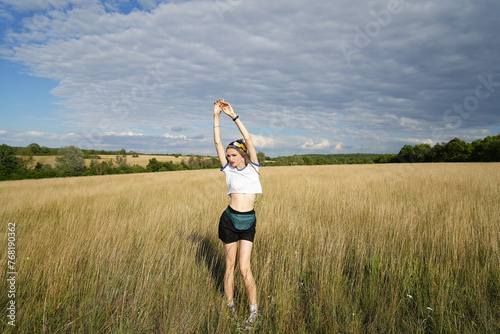 Joyful blonde young woman in the Golden Wheat Field