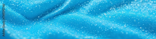 Soft blue fabric covered with water bubbles. Abstract background for design, space for text. 
