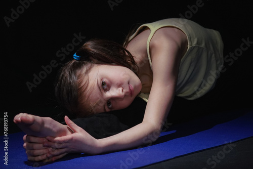 Young yogi girl practicing yoga lesson. Health, gymnastics, breathing, meditation, religion concept. Horizontal image. photo