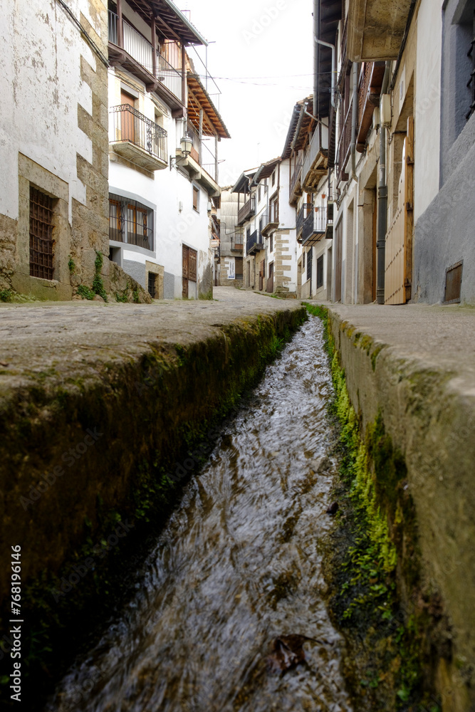 Water flows through the streets of Candelario, Salamanca, Spain.