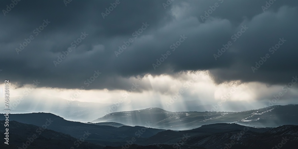 View of mountain range under cloudy sky
