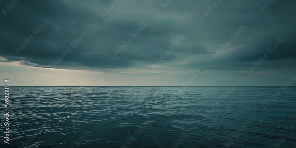 A large body of water reflects the dramatic grey sky above