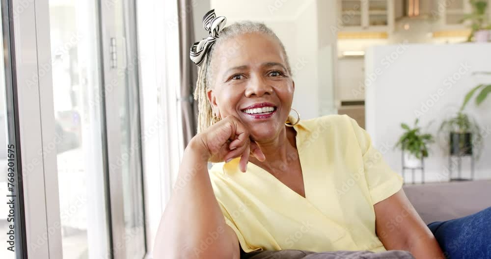 A senior African American woman is laughing joyfully at home A senior African American woman is laughing joyfully at home