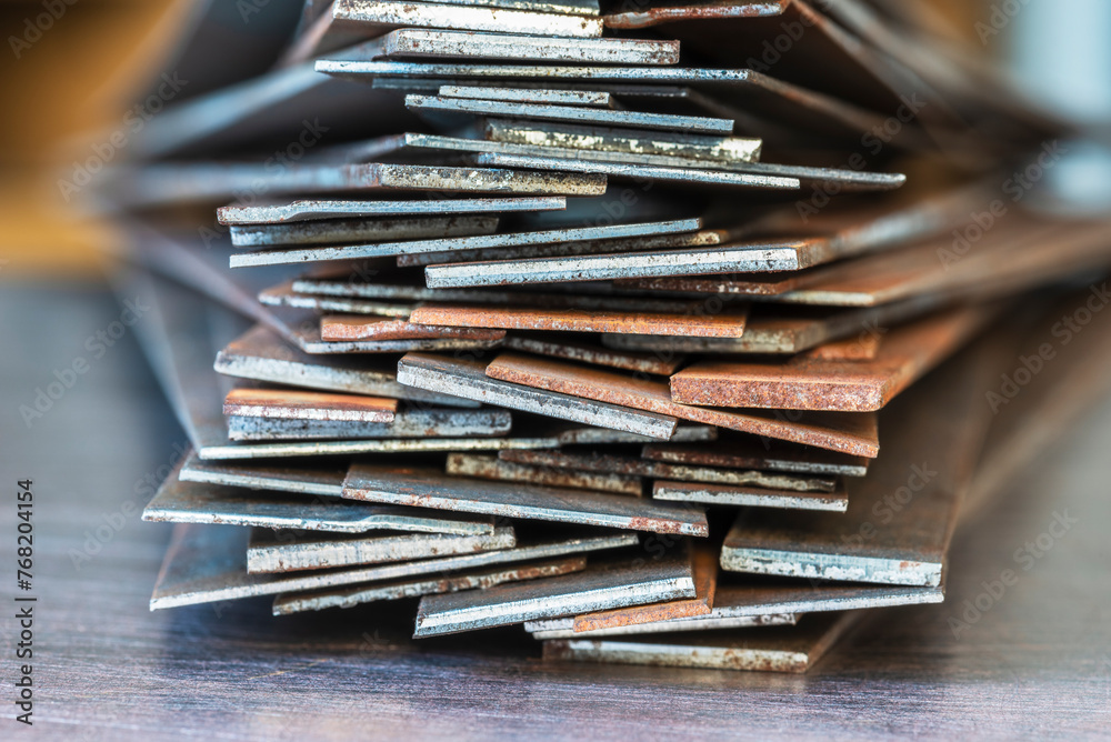 Fototapeta premium Stack of rusty steel flat bar close-up