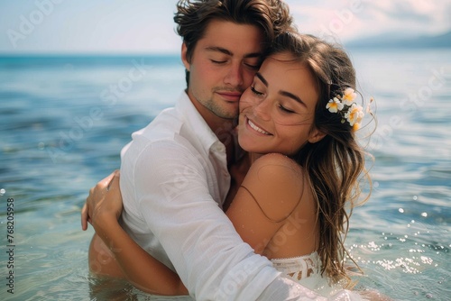 A young couple shares a tender embrace in serene shallow waters, with a serene seascape backdrop