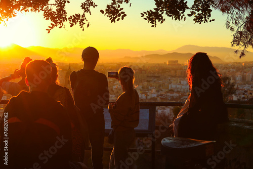 People watching sunset on a hill at Malaga cigty, Spain