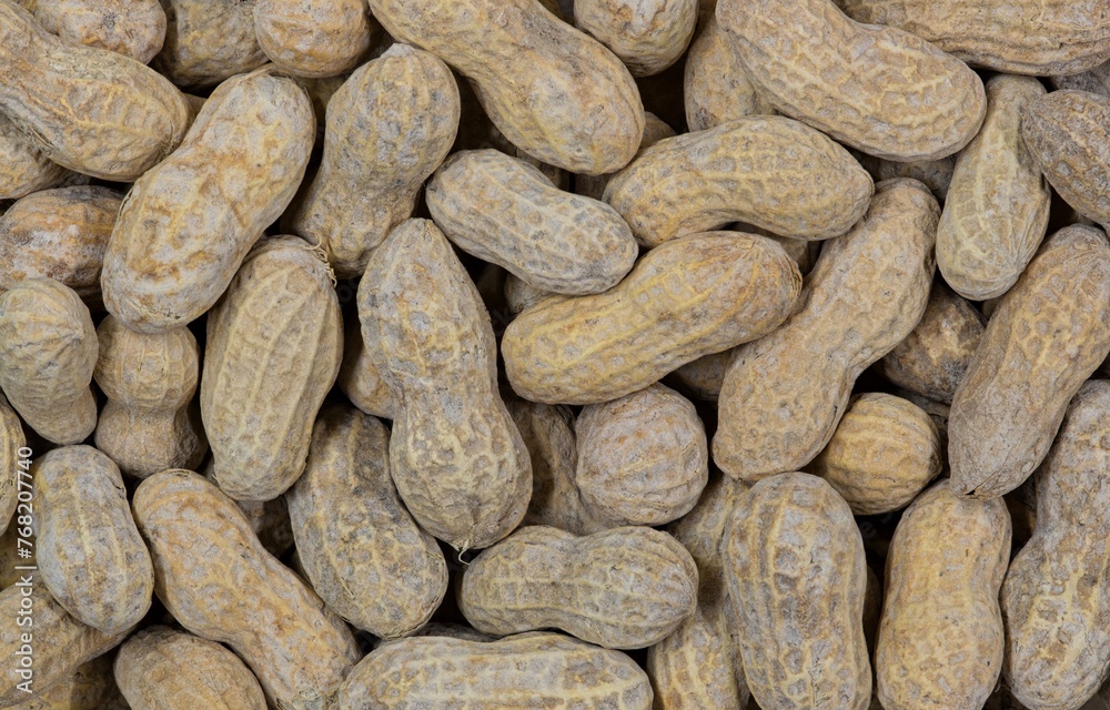Unshelled peanuts scattered flat lay closeup food legume crop nutrition allergy farming industry concept copy space. Unshelled peanuts scattered flat lay closeup food legume crop nutrition allergy farming industry concept copy space.