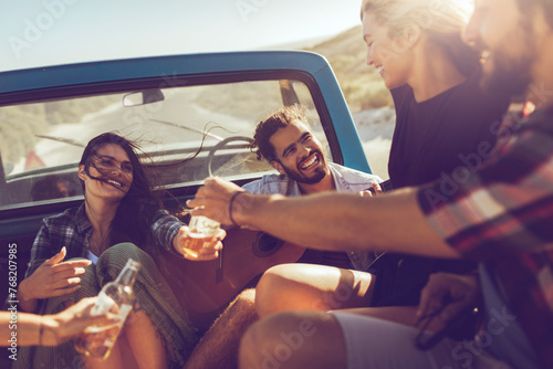 Friends enjoying a road trip with drinks and laughter photo