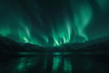 Aurora borealis over mountain peak reflected in sea lake waters at night. Beautiful winter landscape with aurora lights