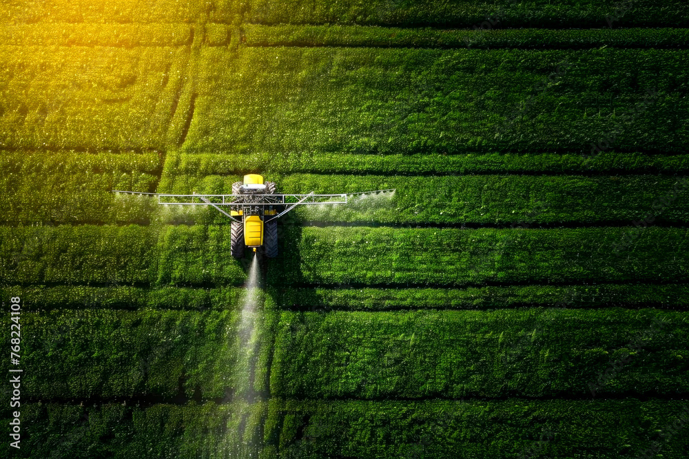 Agriculture tractor spraying fertilizer on agricultural field Agriculture tractor spraying fertilizer on agricultural field