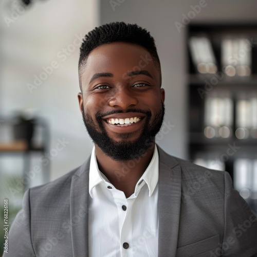 Smiling African American businessman 30-40 years old, active business man against the background of his office