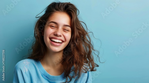 Smiling Woman With Long Hair in Blue Shirt