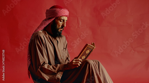 A Muslim who reads the Holy Book, observing Muslim traditions. The concept of Muslim traditions. Ramadan, Eid al-Fitr (Uraza-Bayram), and Eid al-Adha, a place for text on a red background