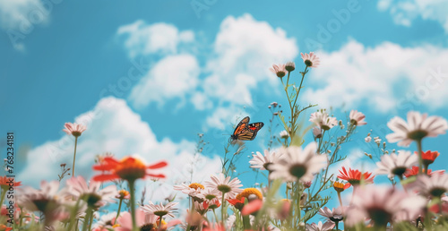 A vibrant and whimsical scene captures a butterfly fluttering amidst a colorful meadow filled with blooming daisies, wildflowers, and fluffy clouds in a brilliant blue sky