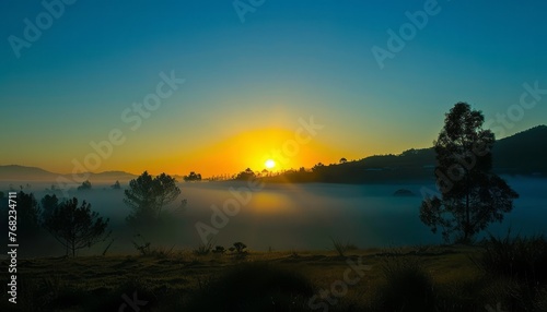 Sun Setting Over Foggy Lake