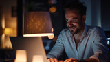 Smiling businessman working late in dark office.
