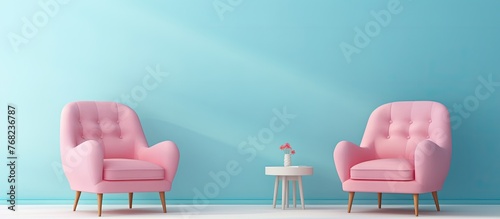 Pair of pink chairs placed in a room with blue walls accompanied by a small table for added functionality