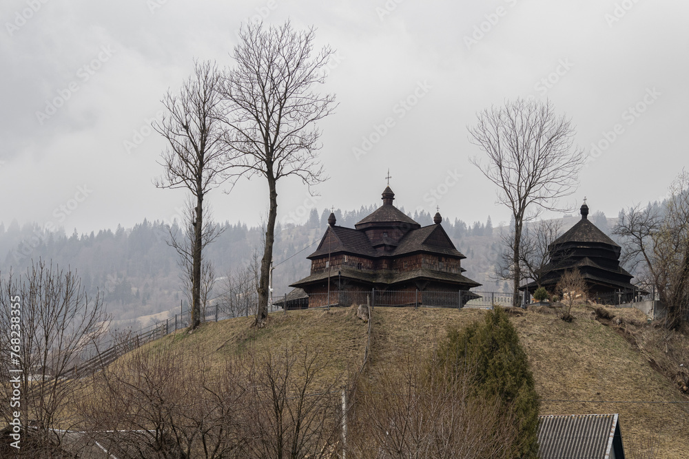 Yasinya, Ukraine. March 17, 2024, early spring, cloudy rainy sky. an incredibly beautiful view of the fog-shrouded mountains. small village houses in which people live Yasinya, Ukraine. March 17, 2024, early spring, cloudy rainy sky. an incredibly beautiful view of the fog-shrouded mountains. small village houses in which people live