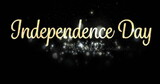 Digital image of gold Independence Day text in cursive with white shiny lights appearing against bla