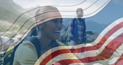 Image of american flag over african american couple smiling in mountains