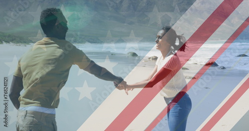 Image of american flag over african american couple dancing at beach