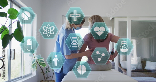 Image of medical icons over senior caucasian woman and nurse exercising