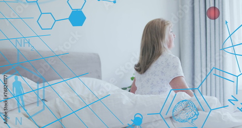 Image of medical icons and molecules over senior caucasian woman in bedroom