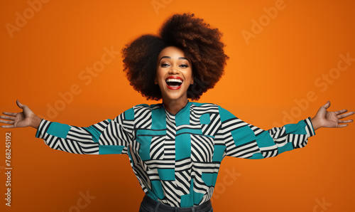 Joyful Fashion Statement: Woman with Vibrant Afro on Orange