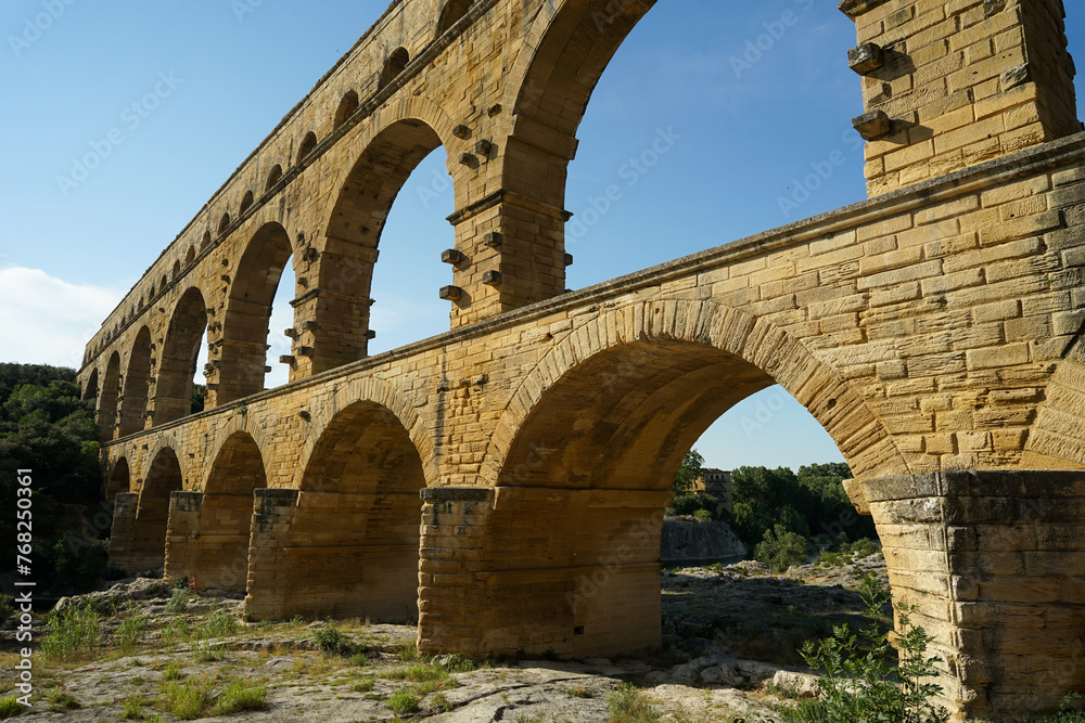 Pont du Gard famous aqueduct bridge with three arched tiers, built in first century by Romans, popular tourist landmark, France
