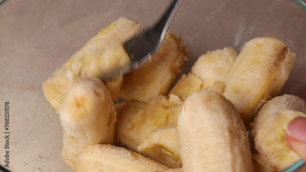 Mash the bananas with a fork. Step by step process of making a banana pie dessert. Mash the bananas with a fork. Step by step process of making a banana pie dessert.