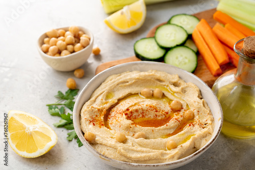 healthy snack fresh hummus with paprika with celery, carrots, cucumber, with chickpeas and olive oil, healthy lunch food
