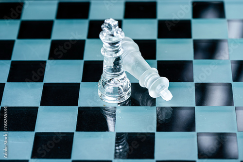 transparent glass chess on dark background, selective focus on king piece, close up photo