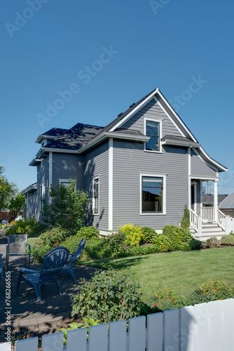 Nestled in scenic greenery, this cozy traditional cottage is embraced by lush shrubs, offering a serene retreat in nature's tranquility.