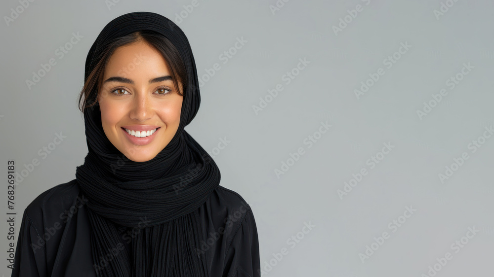 Arab woman wearing black ribbed V-Neck Body smiling isolated on grey Arab woman wearing black ribbed V-Neck Body smiling isolated on grey