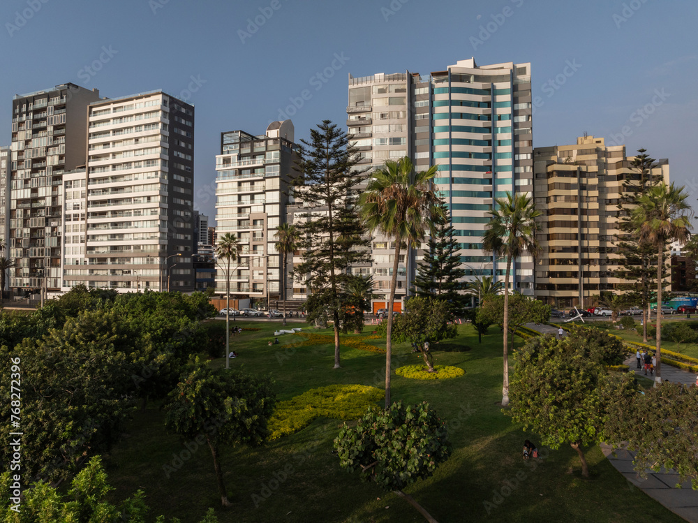 Aerial photograph of buildings on the Malecon of Miraflores, Lima, Peru with the sunset light