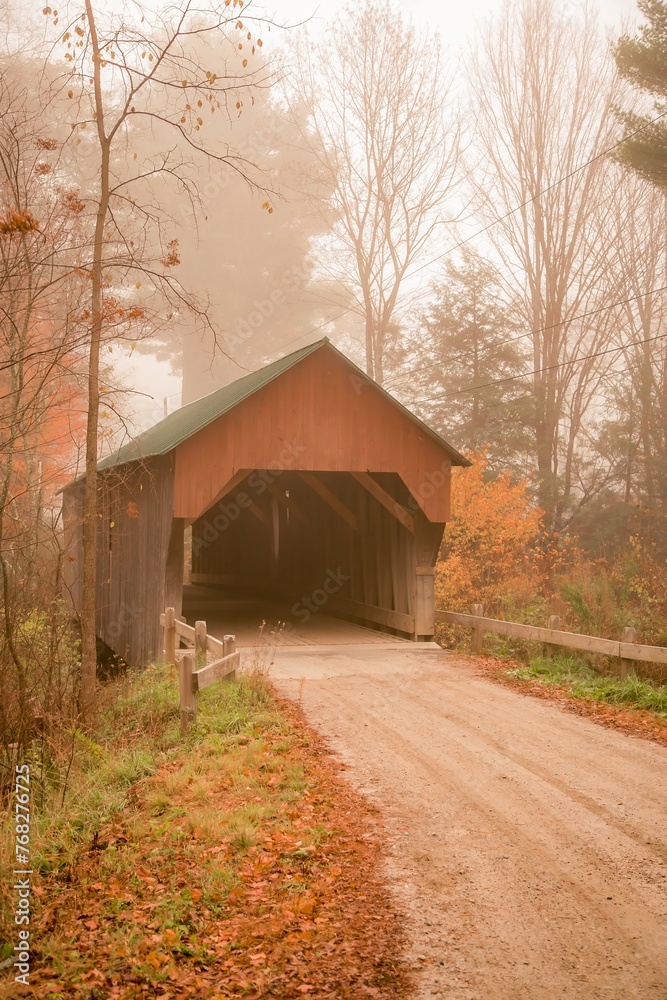 Covered Bridge No 23 in New Hampshire. It is on a Gravel winding road snaking through a forest of autumn colors in near Cornish, NH